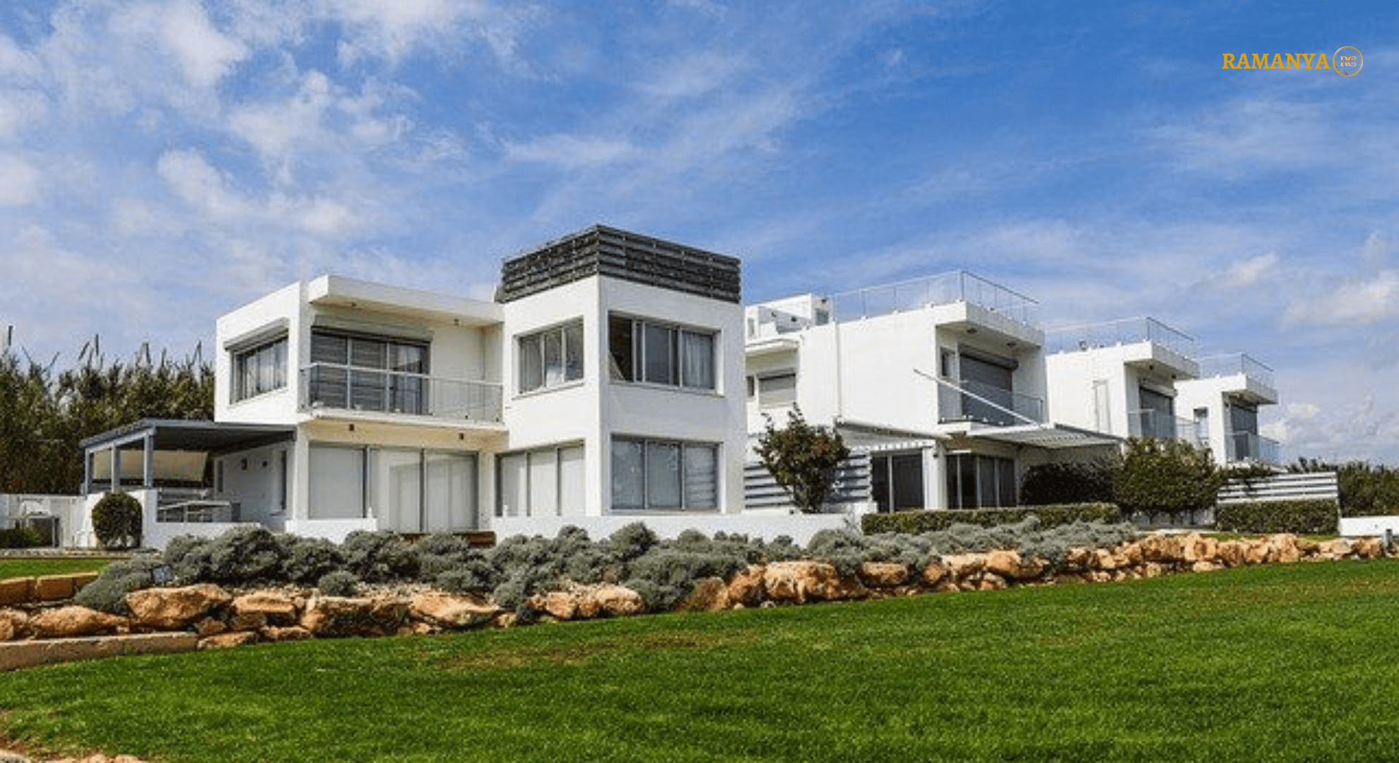 Modern white duplex with green lawn